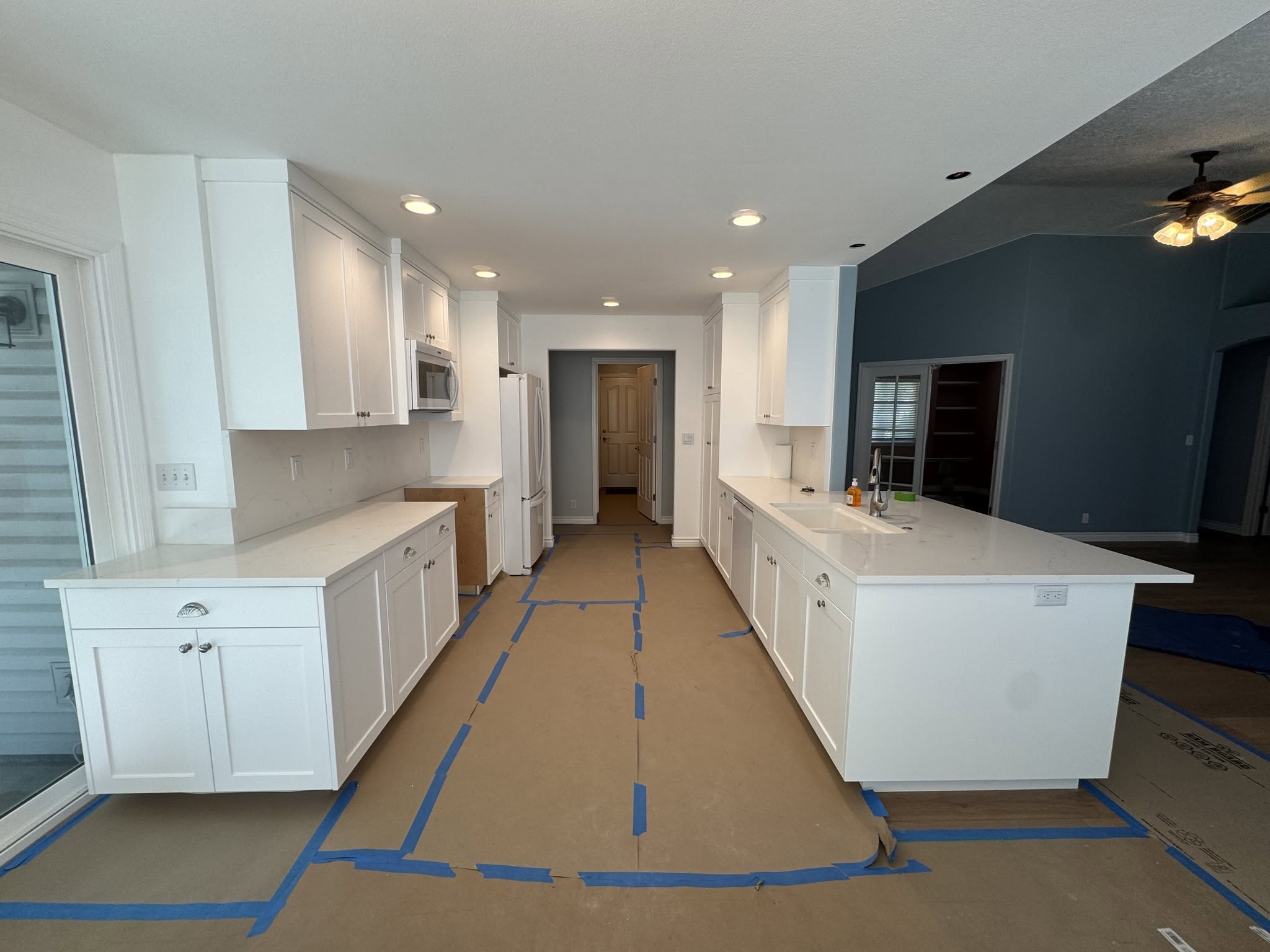 Additional view of the remodeled Meridian kitchen with white cabinetry and peninsula